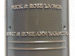 Curved cast bronze plaque for attachment to a light pole